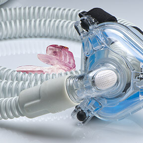 Oral appliance and CPAP mask resting together on table